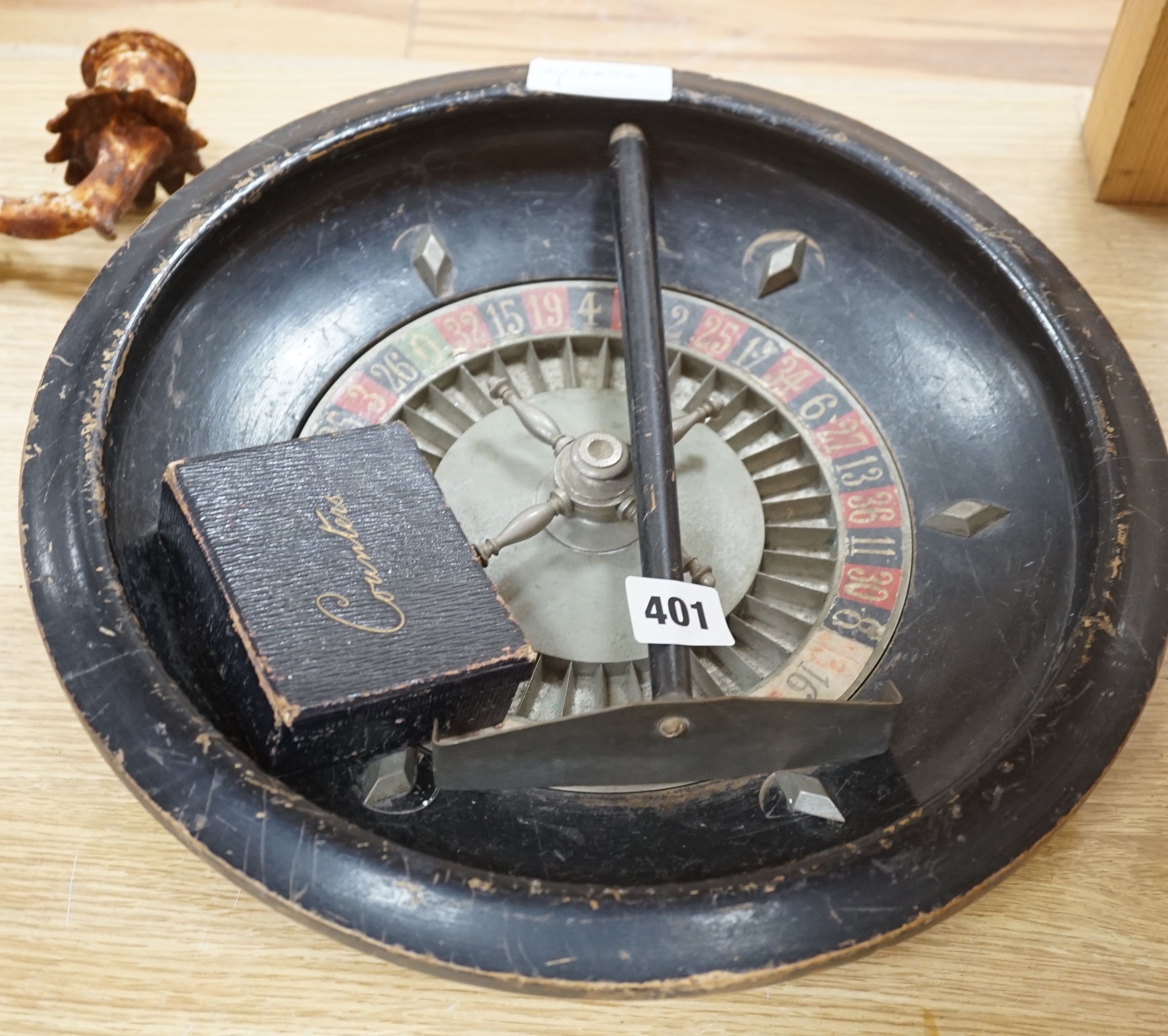 A vintage roulette wheel, chips, push